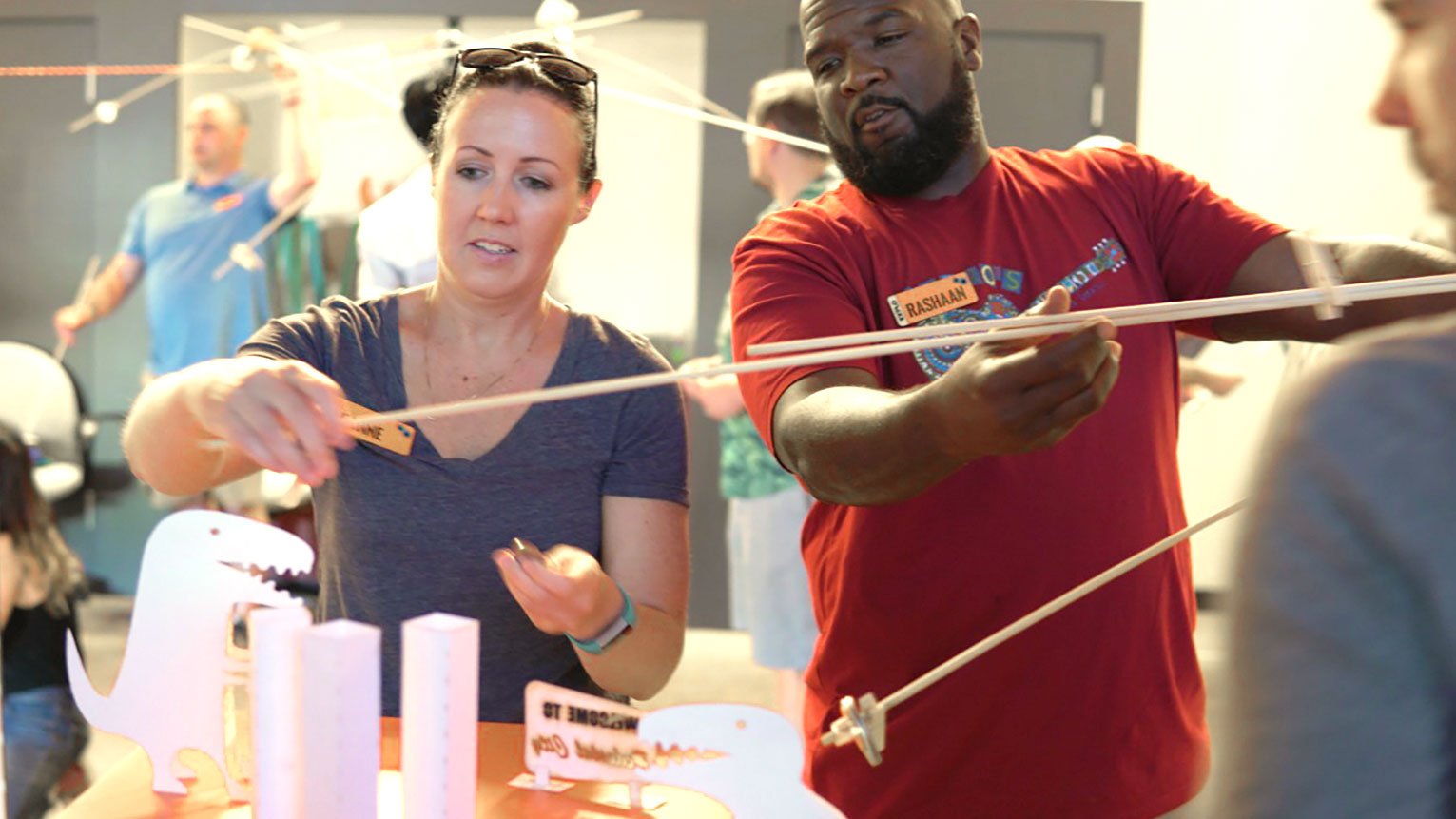 EXPLO's Critical Making Camp for Educators. Exploring topics of balance and weight in relation to physics, participants are challenged to knock down dinosaurs before they destroy Pedestal City.